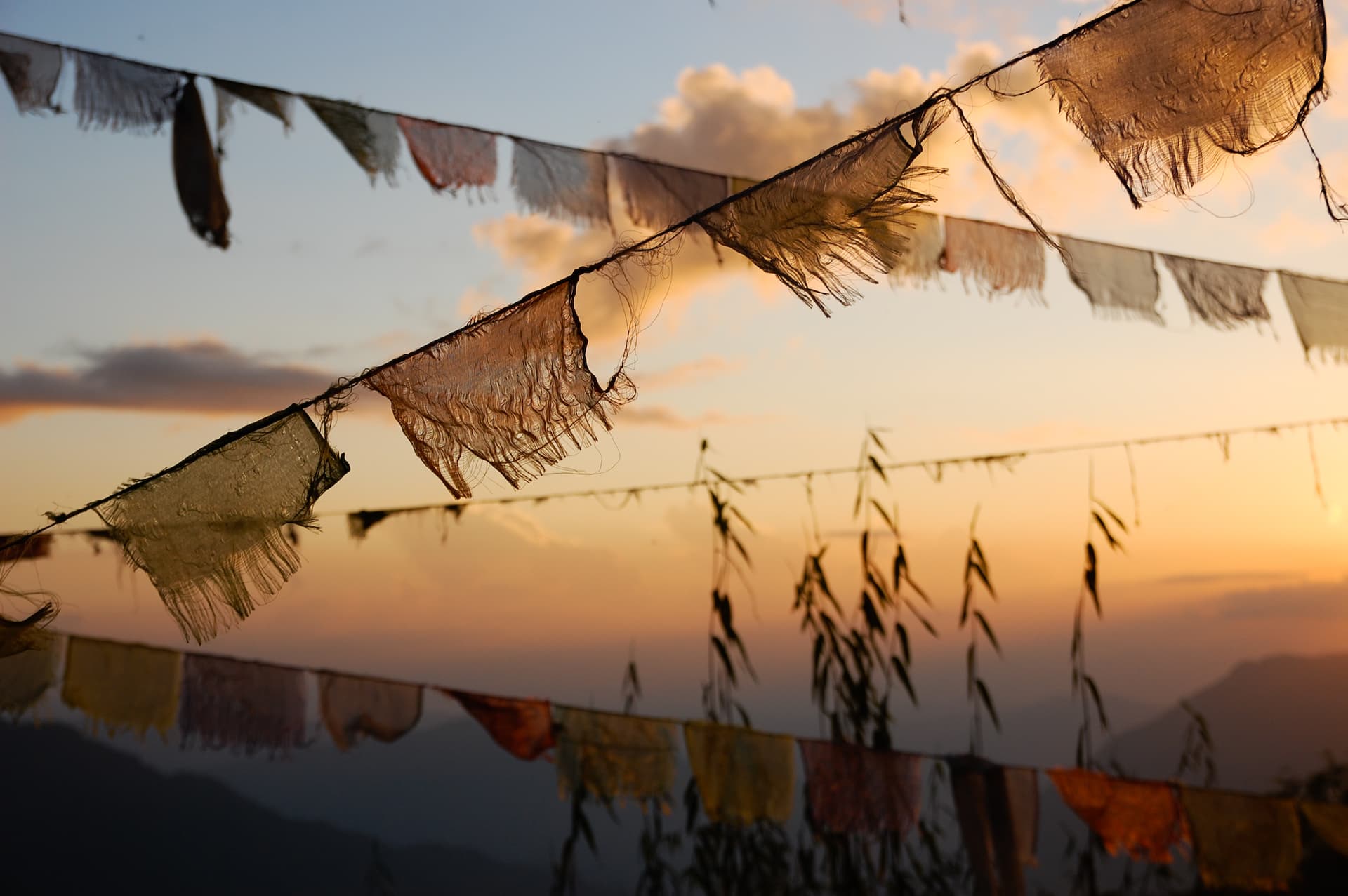 Prayer flags at a Buddhist temple at sundown